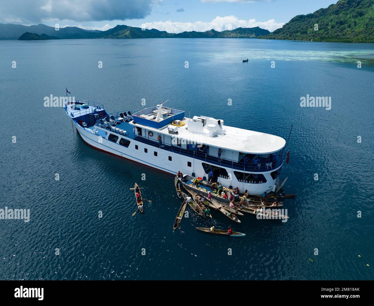 Villagers from a remote island in the Solomon Islands visit a dive boat