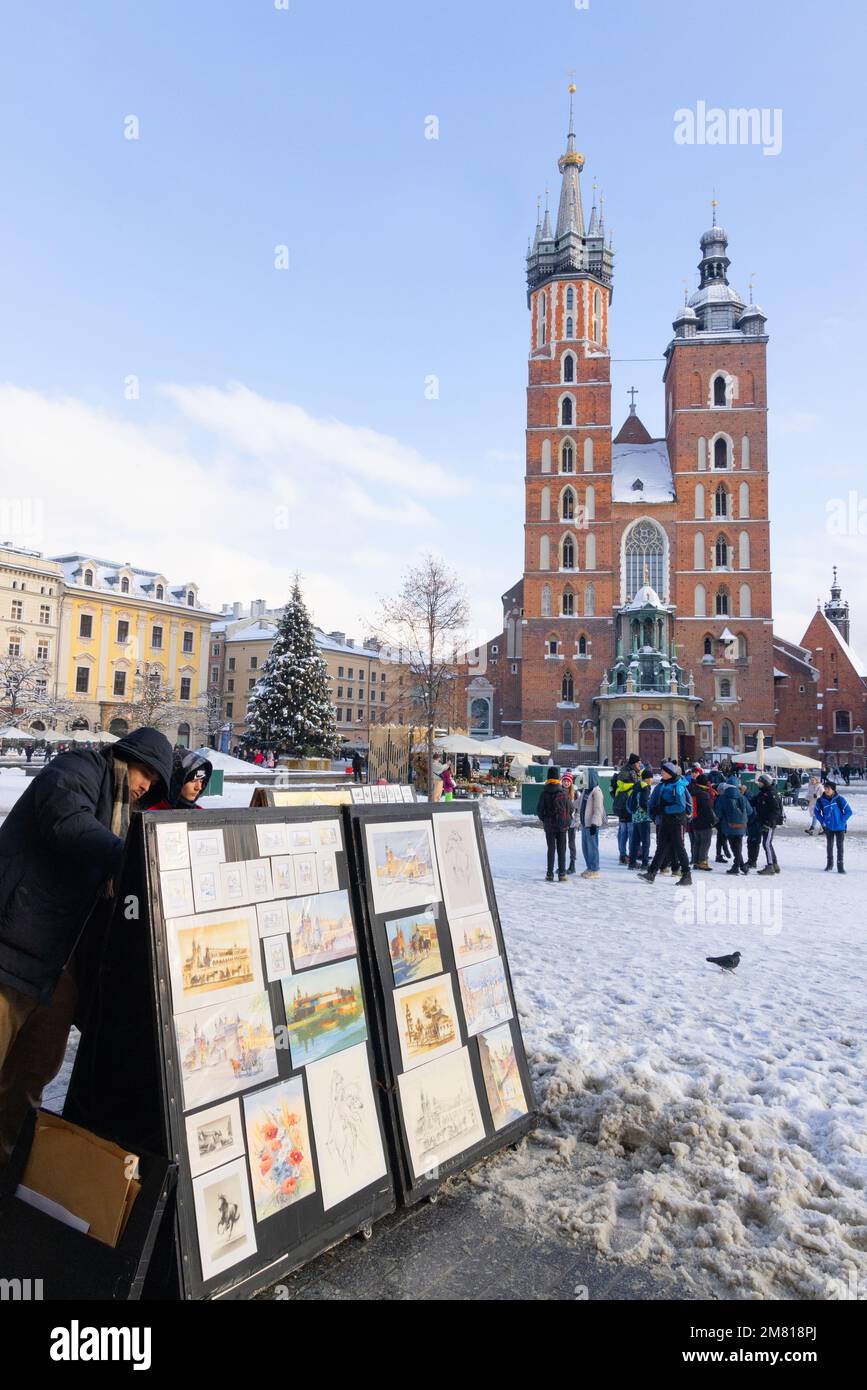 Krakow Market Square, art stall and St Marys Church in winter snow; Krakow Old Town, Krakow Poland Europe. Stock Photo