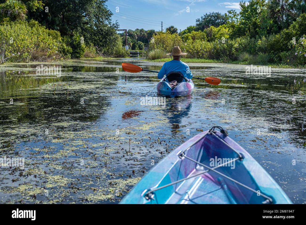 Kayakers on the Guana River approaching Florida SR A1A in Ponte Vedra Beach, Florida. (USA) Stock Photo