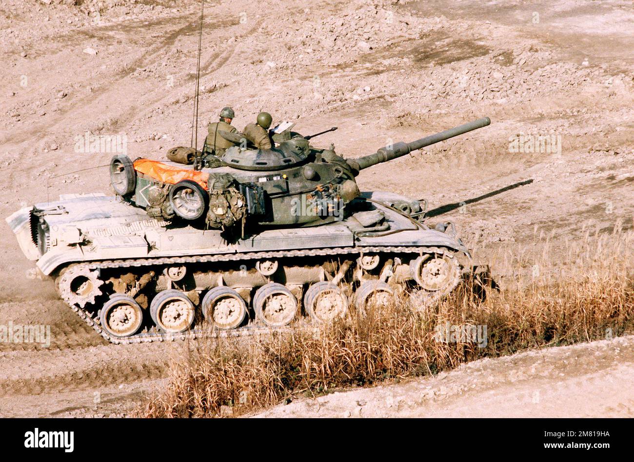 An M-60A1 main battle tank maneuvers downrange at Nightmare Range during a live-fire exercise for Operation Bear Hunt '84. Subject Operation/Series: BEAR HUNT '84 Country: South Korea Stock Photo