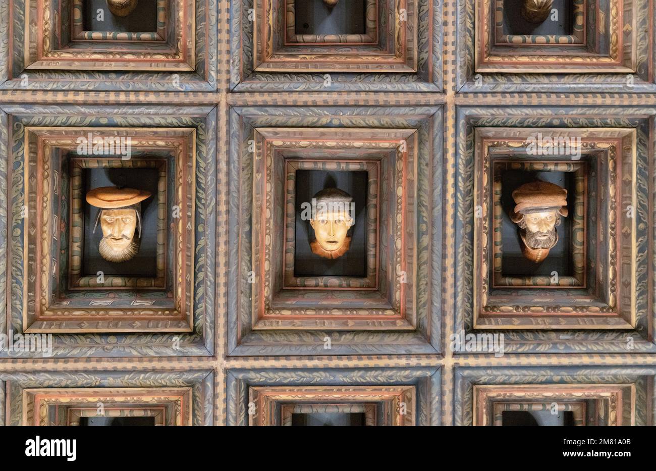 Some of the thirty carved heads on the coffered ceiling of the Envoys Hall, Wawel Castle interior, 15th century; Krakow Old Town, Krakow Poland Europe Stock Photo
