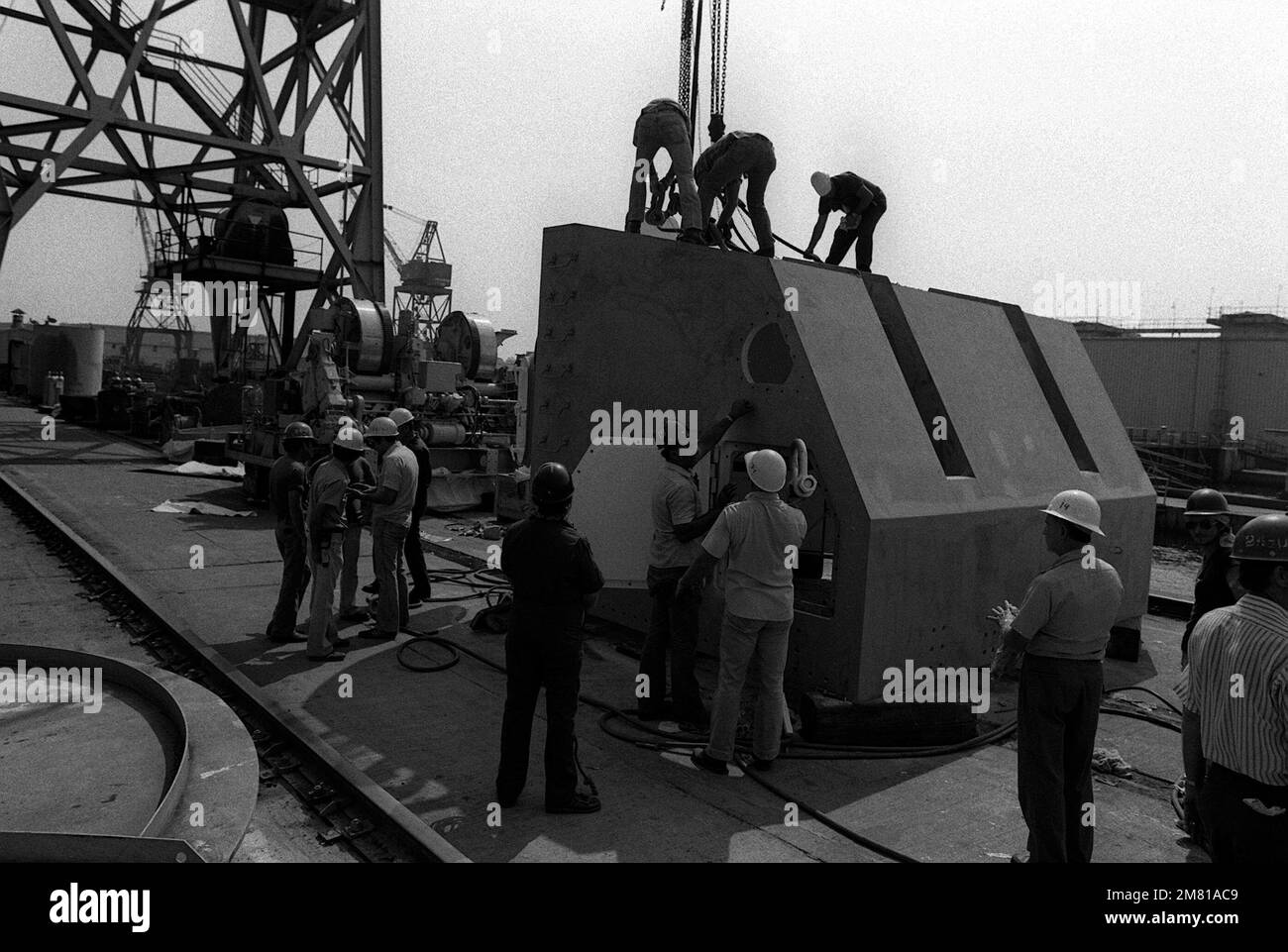 The shield for a Mark 28 5-inch/38 caliber gun is prepared for installation onto the the gun system prior to being placed aboard the battleship IOWA (BB-61) at the Ingalls shipyard. Base: Pascagoula State: Mississippi (MS) Country: United States Of America (USA) Stock Photo