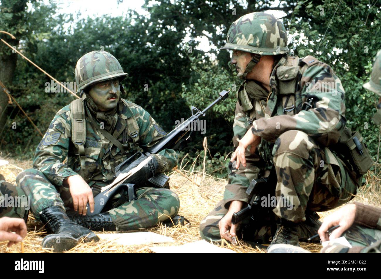 Air Force security personnel, armed with M16A1 rifles and wearing camouflage paint, participate in Operation URGENT FURY. Subject Operation/Series: URGENT FURY Country: Grenada (GRD) Stock Photo