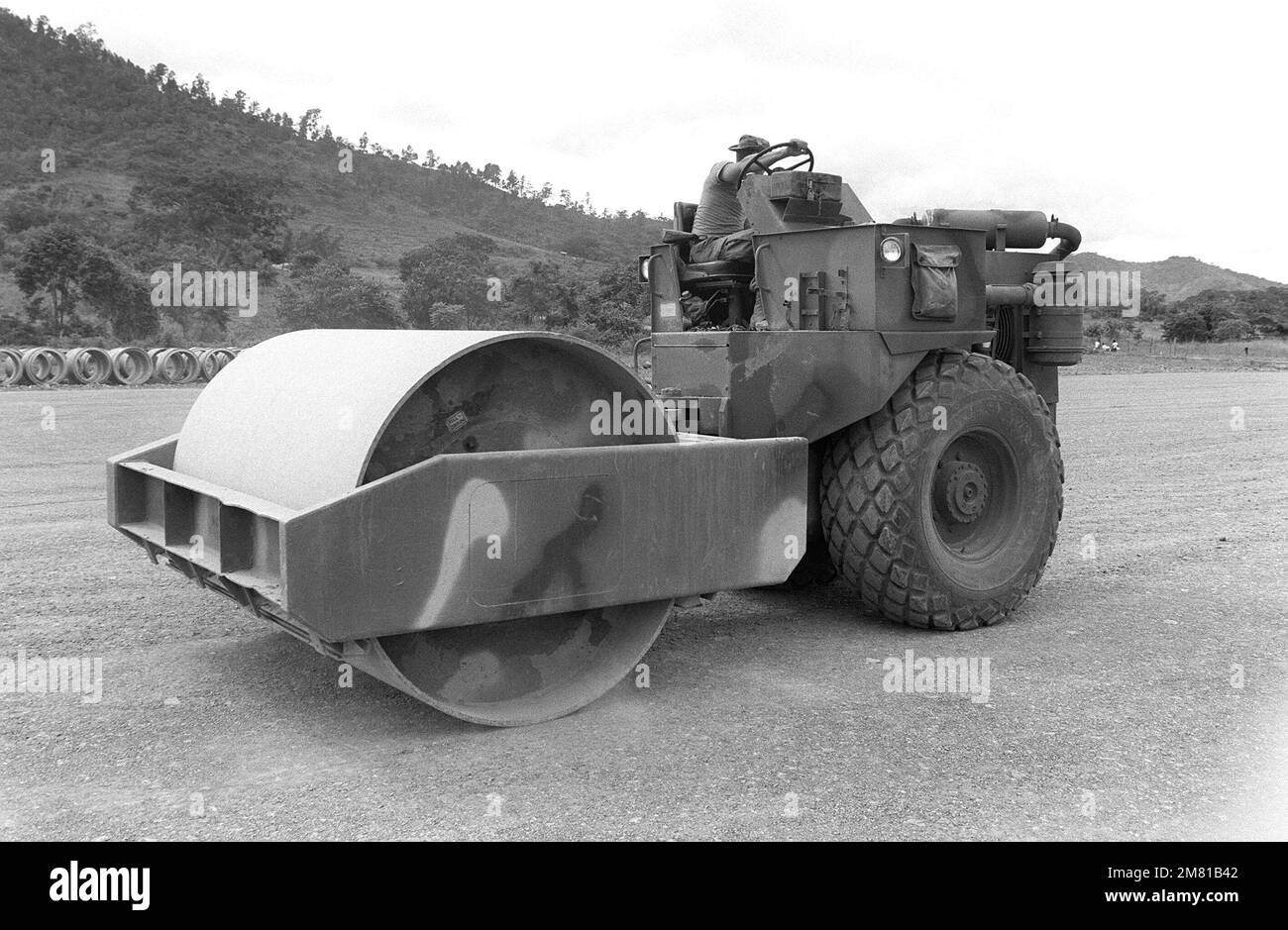 A steamroller is used by the 46th Engineers as they construct an airstrip during the AHUAS TARA II (BIG PINE) operation. Subject Operation/Series: AHUAS TARA II (BIG PINE) Base: Aguacate Country: Honduras (HND) Stock Photo