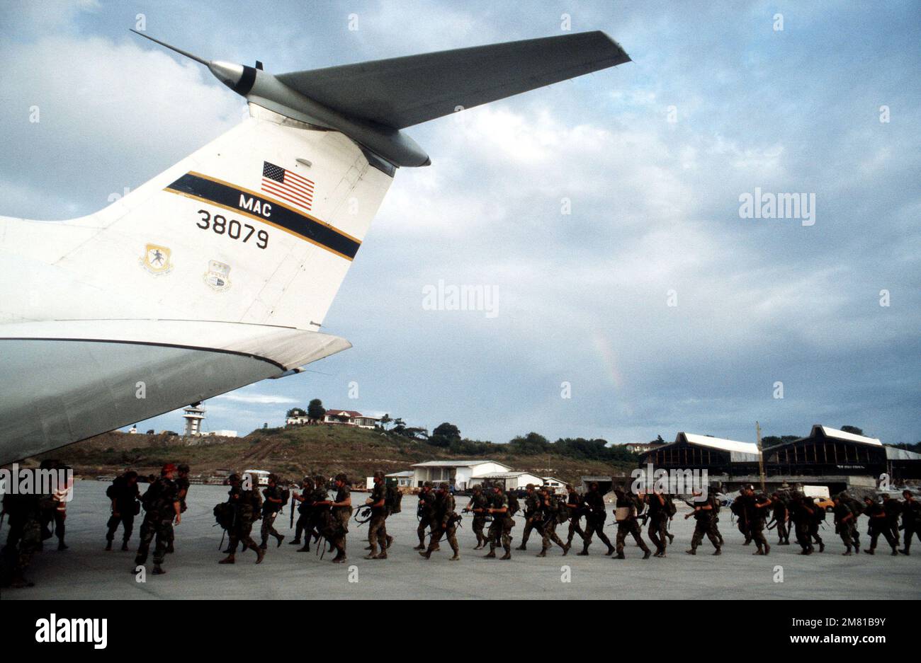 US military personnel board a C-141B Starlifter aircraft at Point ...