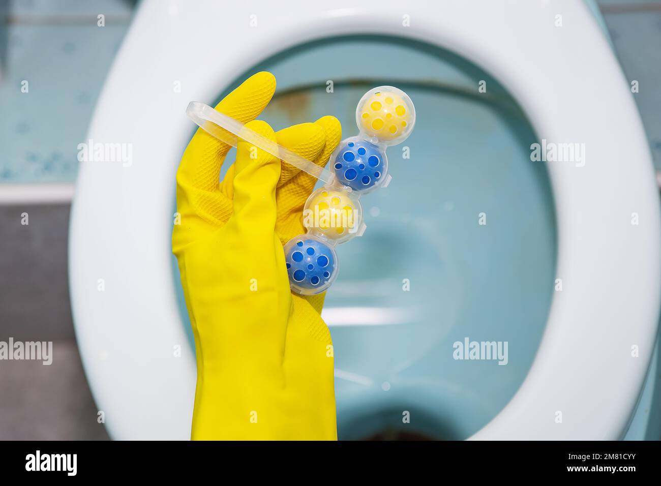 A yellowblue plastic toilet block that cleans the walls of the toilet