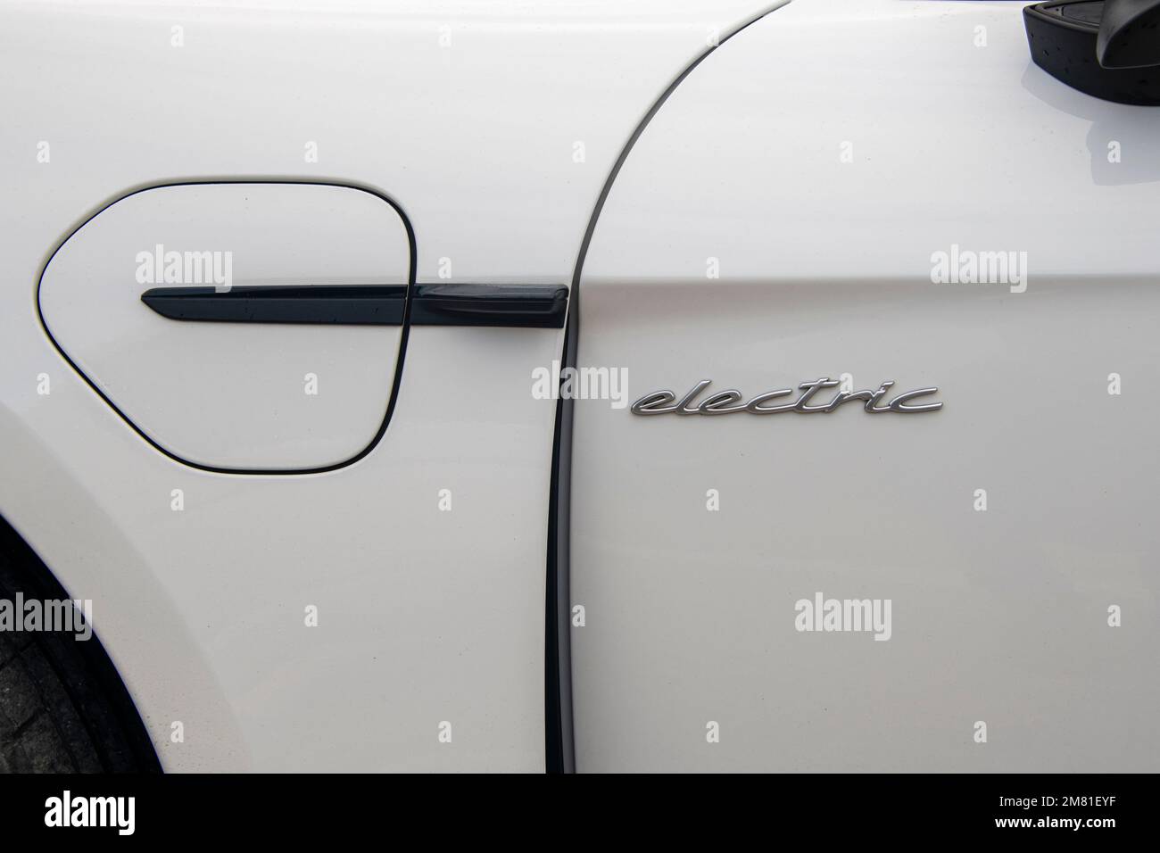 Side of a modern electric car with charging cap. Stock Photo