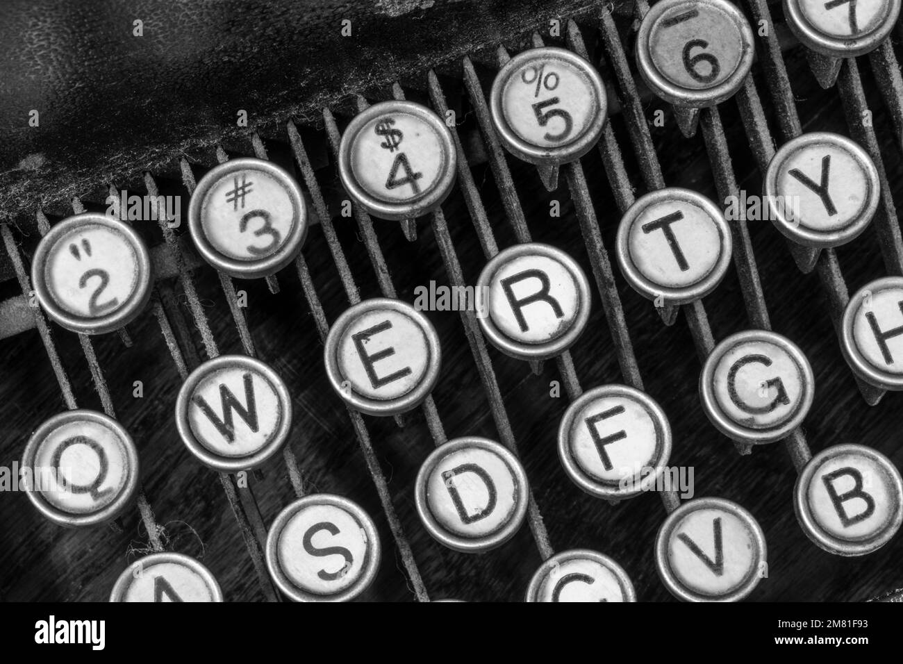 Antique typewriter showing traditional QWERTY keys. Before text messaging, people used typewriters to communicate by writing letters. Stock Photo