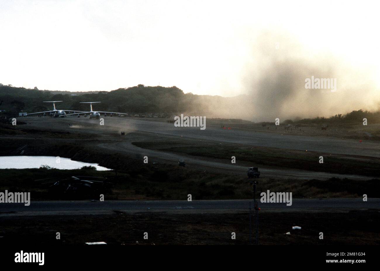 Two C-141B Starlifter aircraft on the runway at Point Salines Airport ...