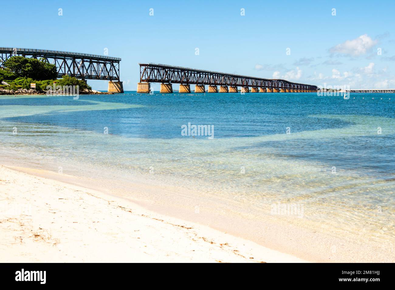 Abandoned Florida Overseas railway bridge over blue ocean water of Gulf of Mexico, Calusa beach in Florida Keys, Bahia Honda State Park, Stock Photo