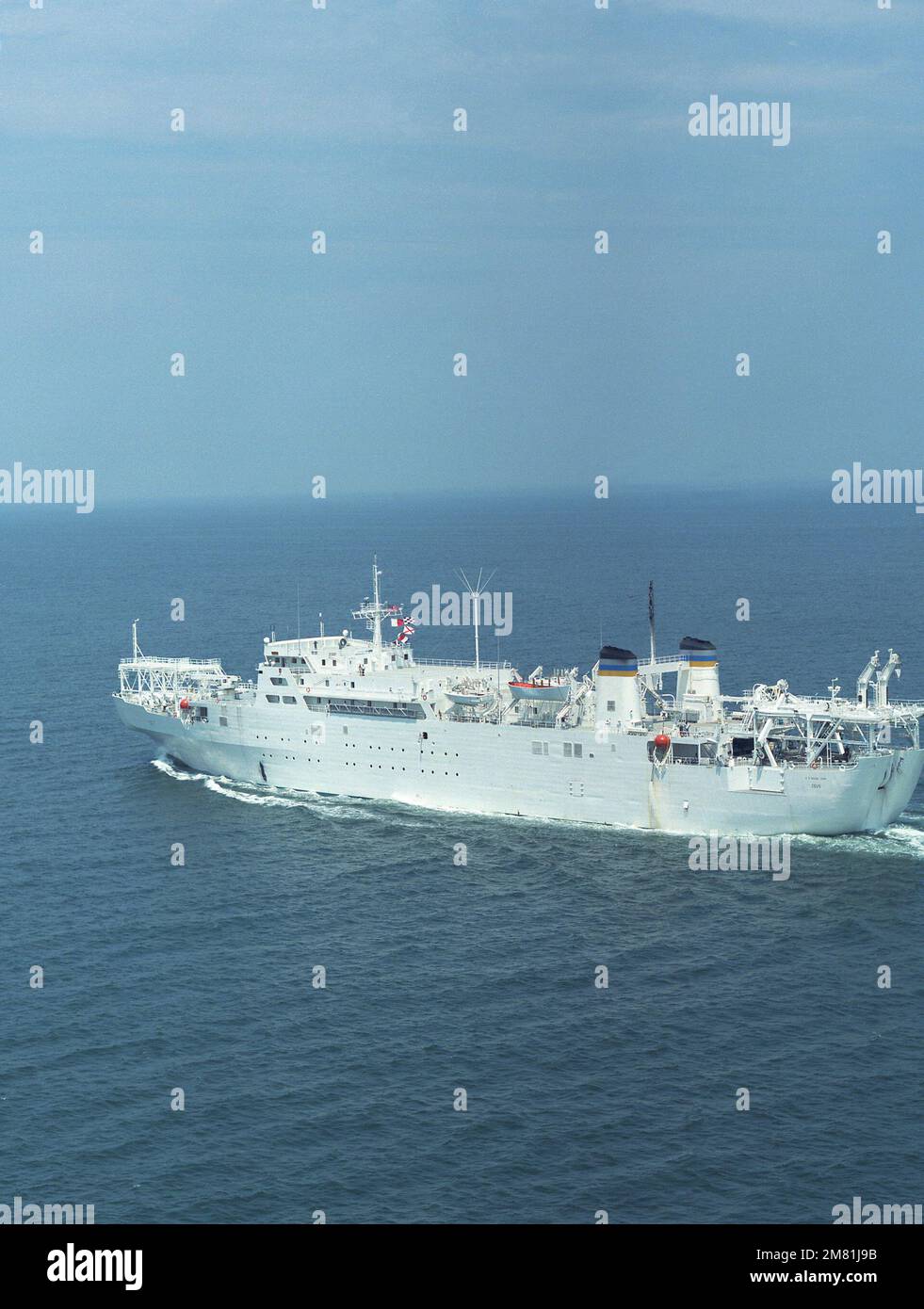 An aerial port quarter view of the cable repair ship USNS ZEUS (T-ARC-7) underway. Country: Unknown Stock Photo