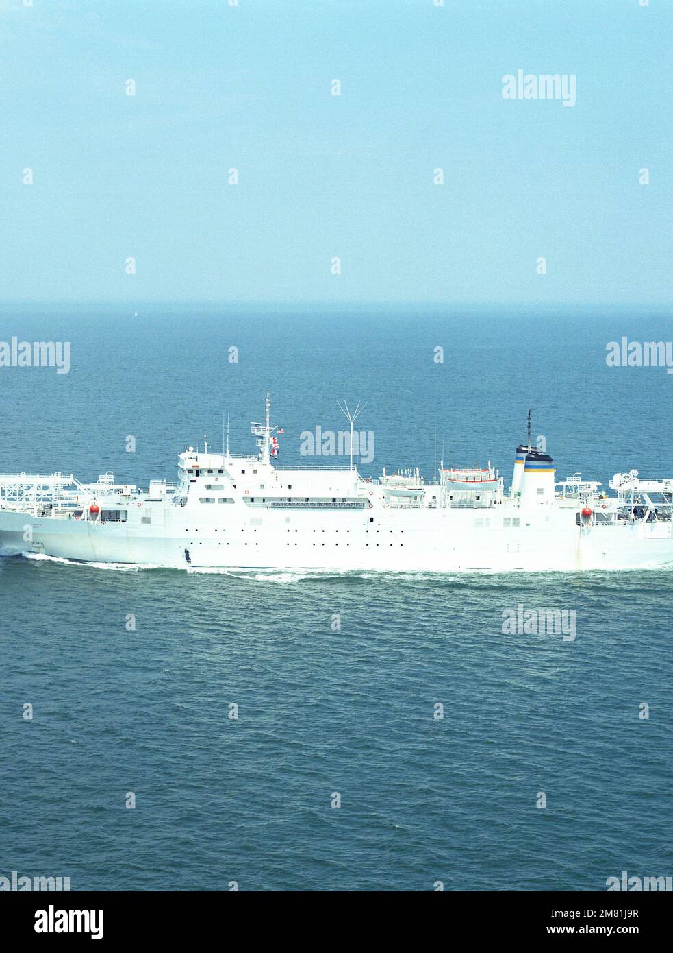 An aerial port beam view of the cable repair ship USNS ZEUS (T-ARC-7) underway. Country: Unknown Stock Photo