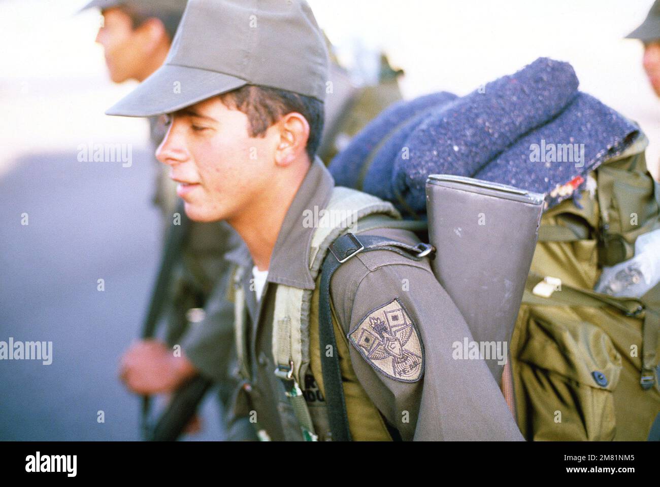 A Honduran soldier boards a C130 Hercules aircraft provided by the