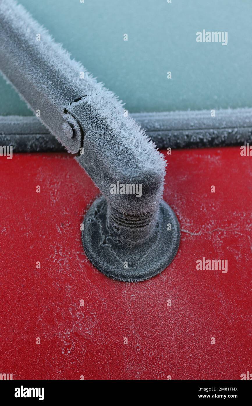 Close up image detailing the jewel like frost coating on a rear window wiper arm on a hatchback car. Stock Photo