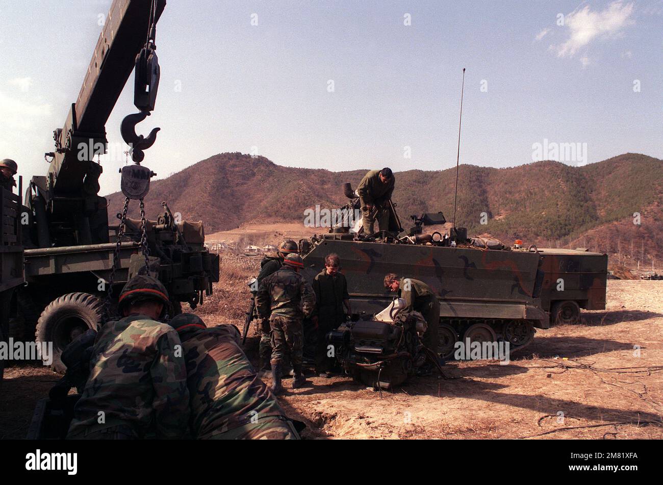 Members of the 2nd Forward Support Bn., 25th Inf. Div., perform maintenance on an M-113A2 armored personnel carrier engine during the joint South Korean/U.S. training exercise Team Spirit '84. Subject Operation/Series: TEAM SPIRIT '84 Base: Hongchon Country: Republic Of Korea (KOR) Stock Photo