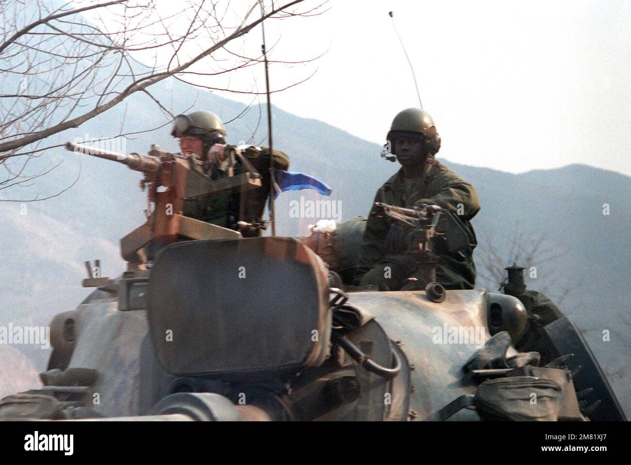 US Army personnel aboard an M-48A5 main battle tank during the joint South Korea/US Exercise Team Spirit '84. The soldier at left mans an anti-aircraft machine gun. Subject Operation/Series: Team Spirit '84 Country: Republic Of Korea (KOR) Stock Photo