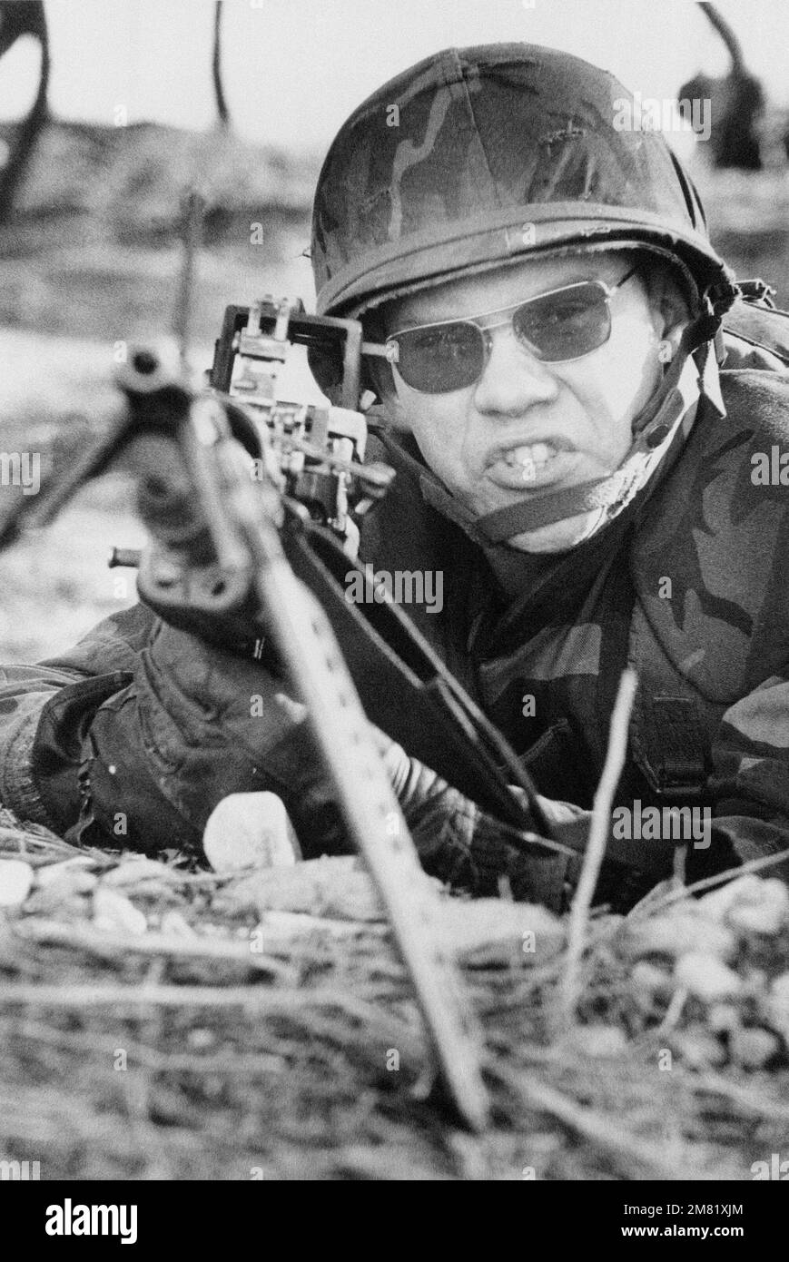 A US Marine mans an M60 machine gun as Republic of Korea and US Forces secure the beach during TEAM SPIRIT '84. TEAM SPIRIT is a joint/combined operation designed to test and improve techniques to defend the Republic of Korea Peninsula and increase combat readiness of Republic of Korea and US armed forces. Subject Operation/Series: TEAM SPIRIT '84 Base: Tok Sok Ri Beach Country: Republic Of Korea (KOR) Stock Photo