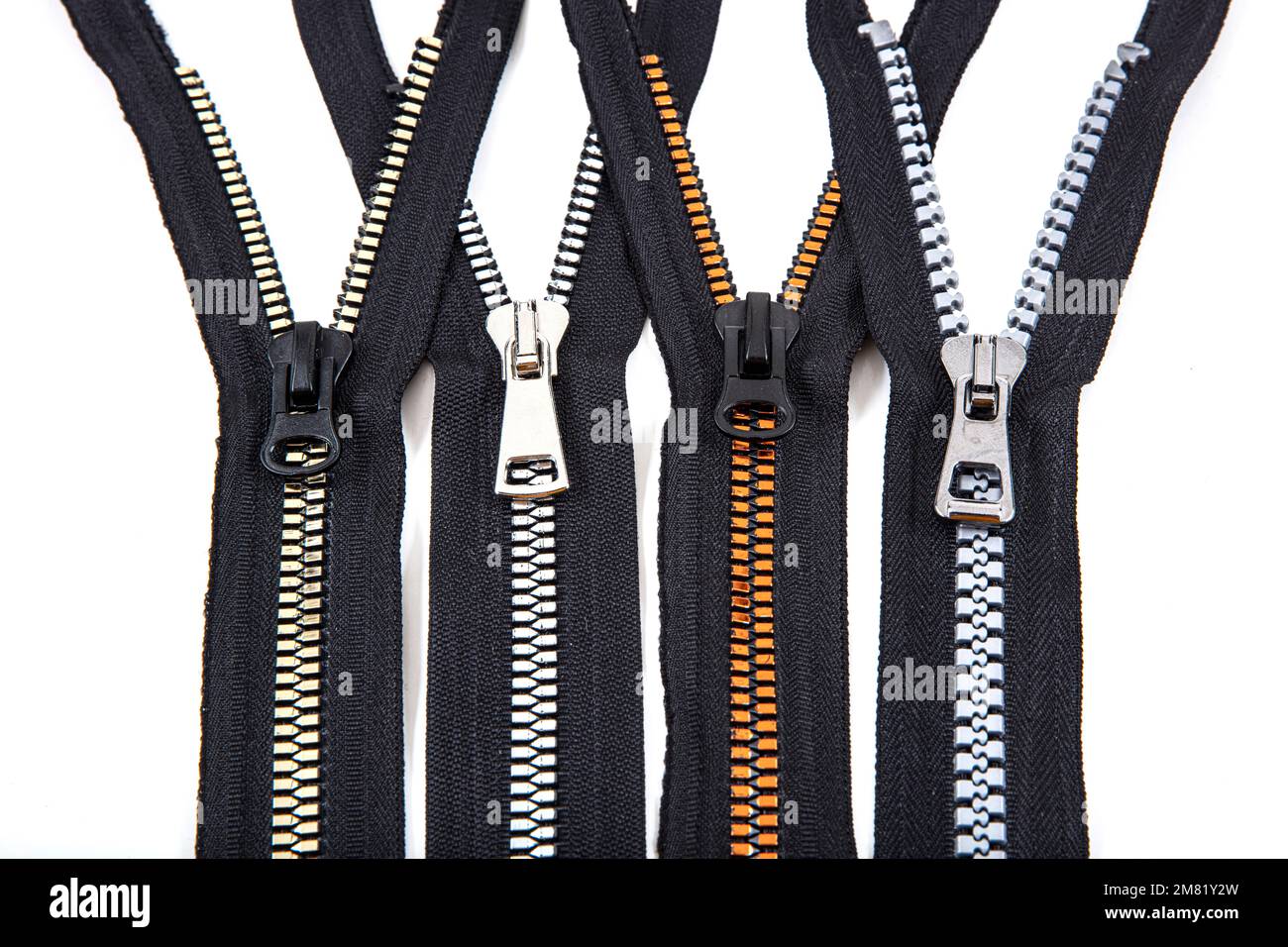 Jacket Winter Coat Black Tape Heavy Duty Zippers Large Molded Plastic Zippers. Close-up of zipper slider on a white surface. Sewing production, materi Stock Photo