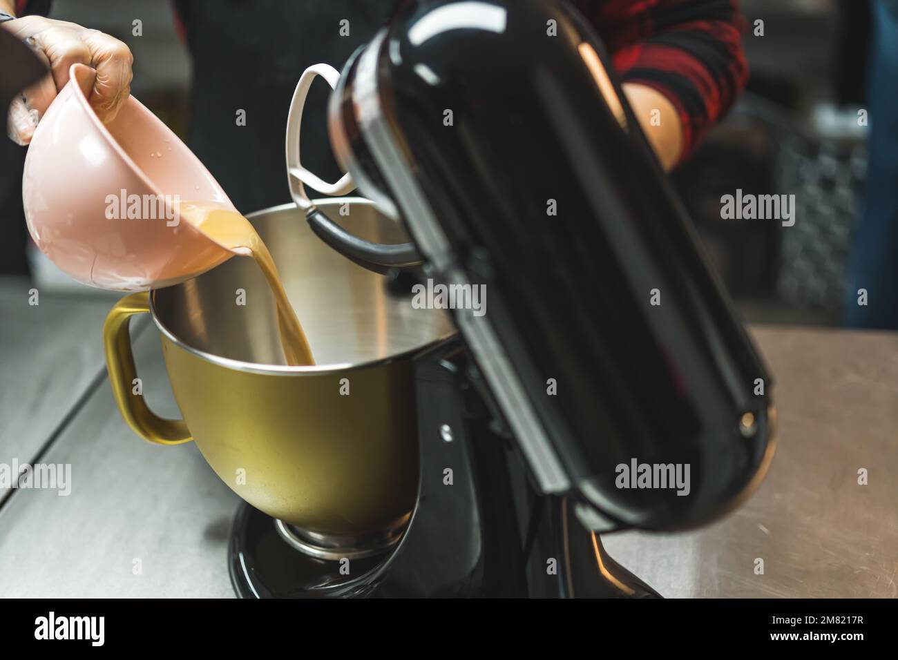 Unrecognizable person baking, using stand mixer in kitchen. Using food