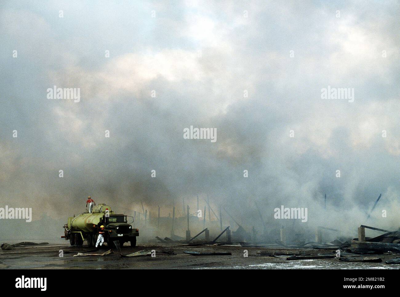 A firetruck from the 3rd Civil Engineering fire department is manned by American and Filipino firefighters attempting to extinguish the fire engulfing the U.S. Facilities 3rd Supply Squadron covered storage area 11A. Damages were estimated to be $3 million. Base: Clark Air Base State: Luzon Country: Philippines (PHL) Stock Photo