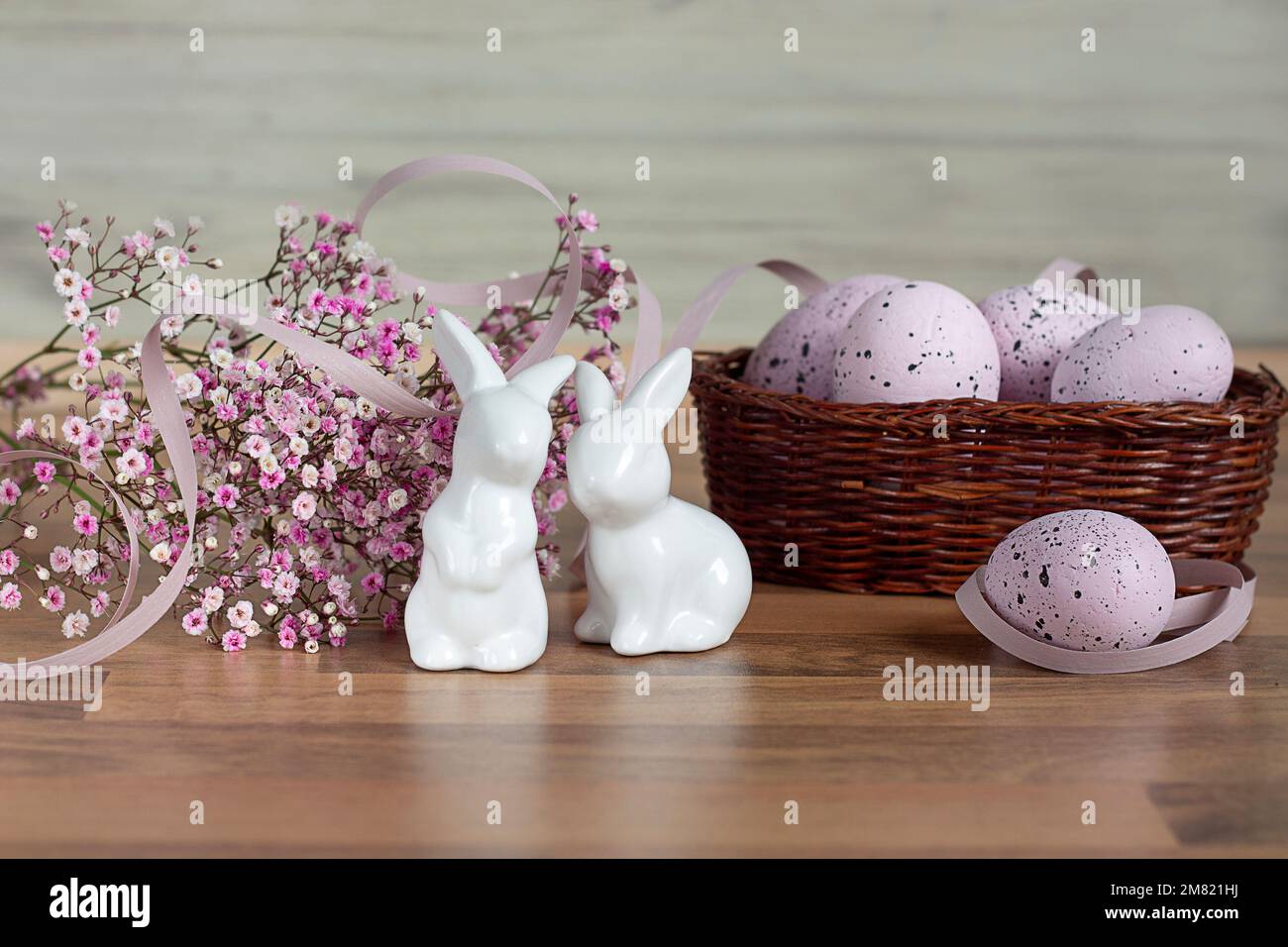Easter background with colored Easter eggs and blooming flowers. Two Easter Bunnies. Easter composition. Easter. Copy space Stock Photo