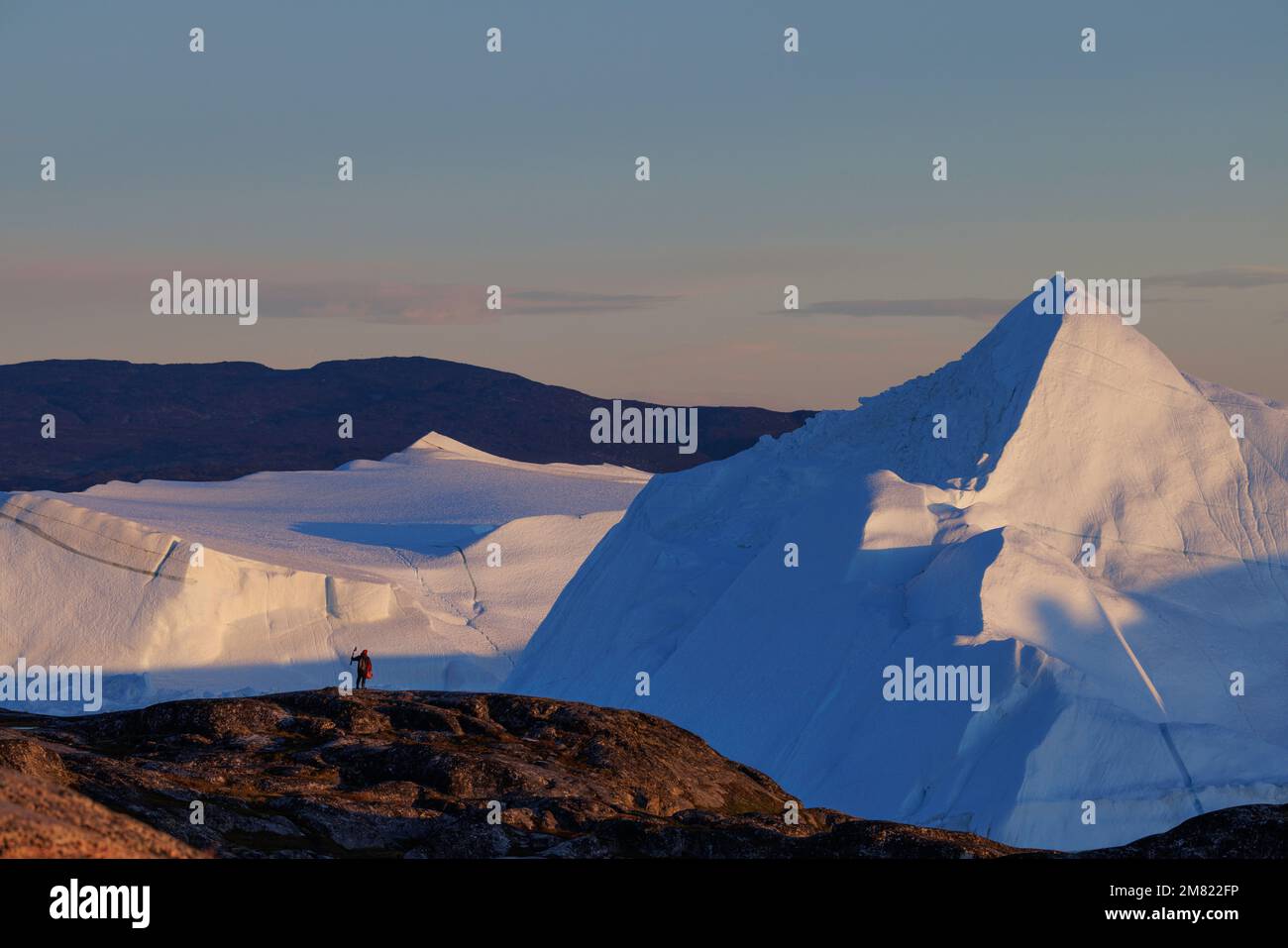 man observe iceberg floating over sea Stock Photo