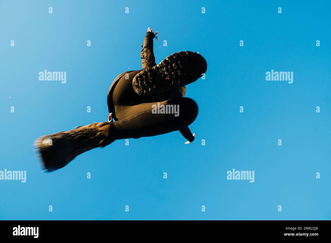 nadir photography of woman jumping against blue sky Stock Photo - Alamy