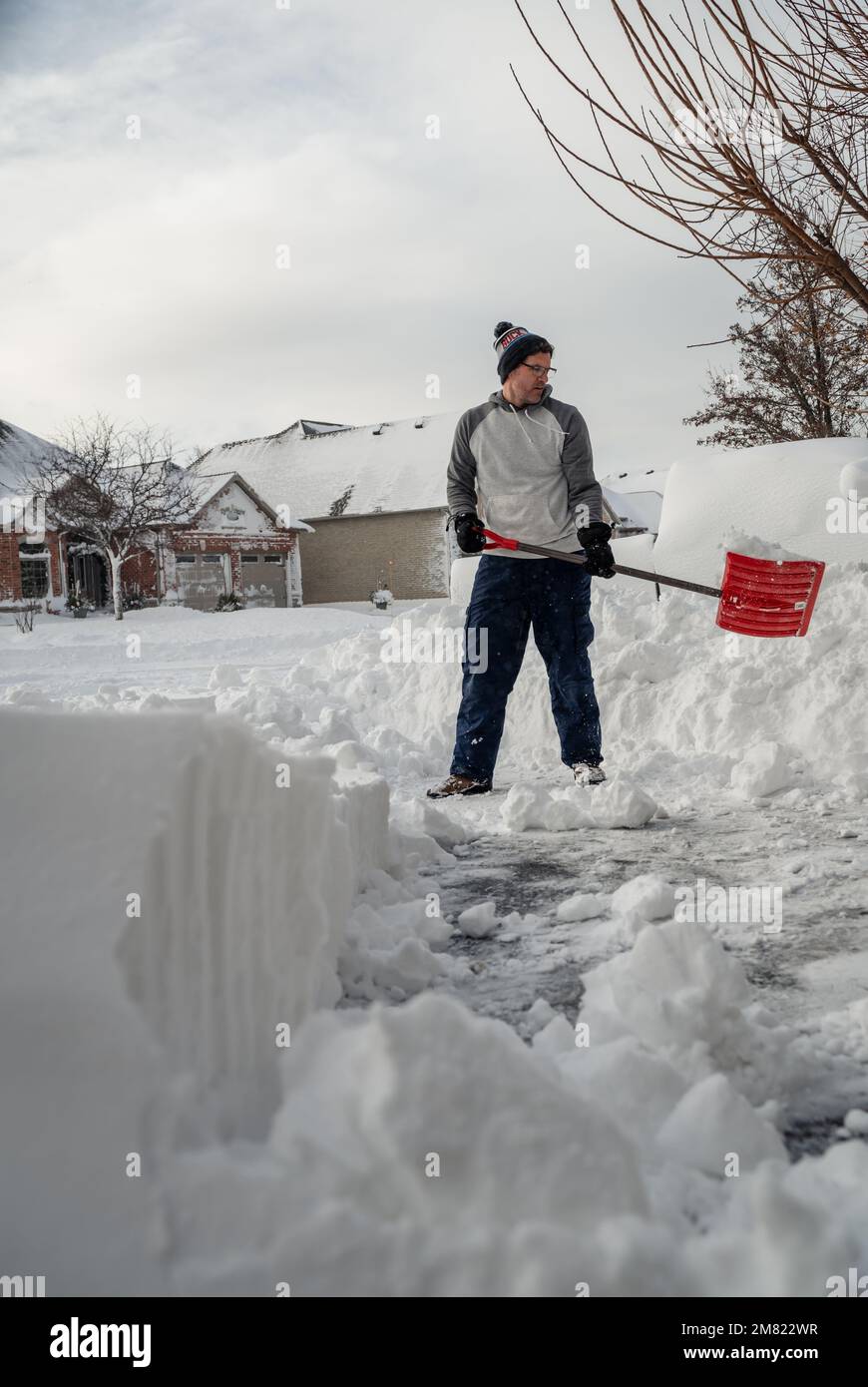 Man shoveling snow off of his driveway after a winter storm Stock Photo Alamy
