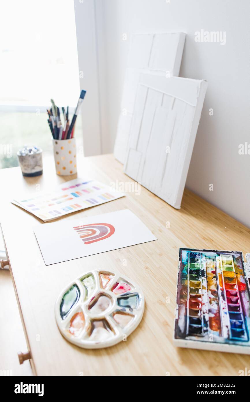 Desk with Watercolor and Art Materials Stock Photo