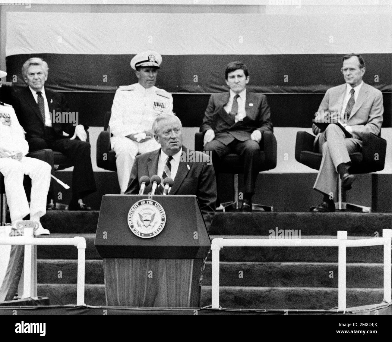 Leonard Erb, senior Vice-President of Litton Industries, Inc., speaks during the commissioning ceremony for the battleship USS IOWA (BB 61). Seated behind him are, right to left: Vice President George Bush, Secretary of the Navy John Lehman Jr., and Admir. Base: Pascagoula State: Mississippi (MS) Country: United States Of America (USA) Stock Photo