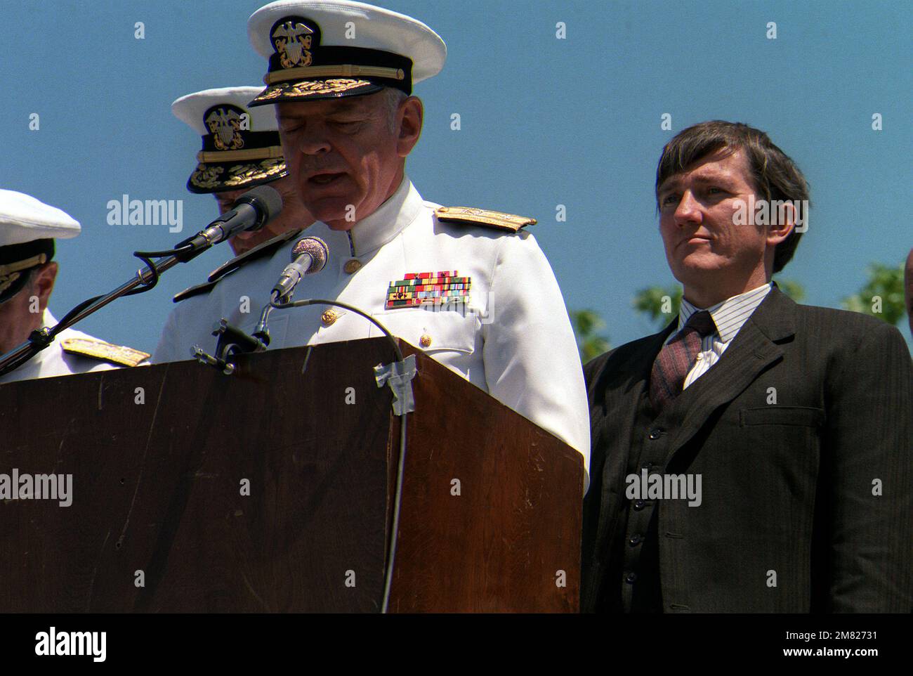 Chaplain (Commodore) John R. McNamara delivers the invocation at the ground breaking ceremony for the United States Navy Memorial in Market Square Park. Secretary of the Navy John Lehman stands to the right. Base: Washington State: District Of Columbia (DC) Country: United States Of America (USA) Stock Photo