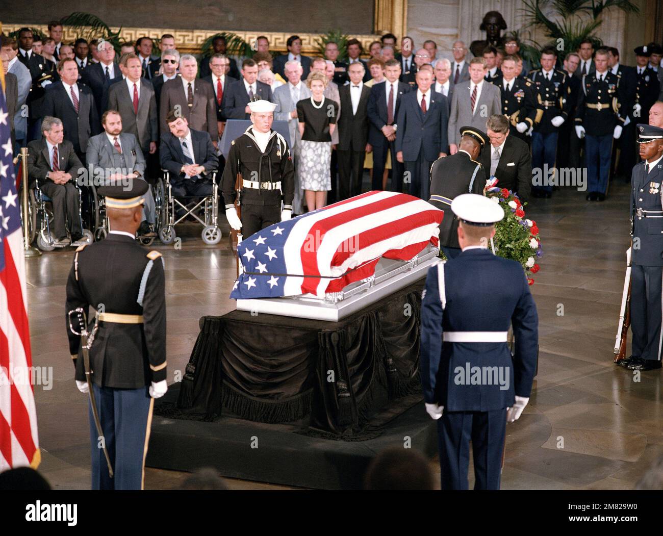 President Ronald Reagan places a wreath at the base of the casket of ...