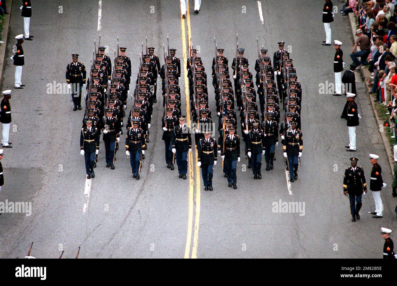 Army servicmen march in formation in the funeral procession honoring