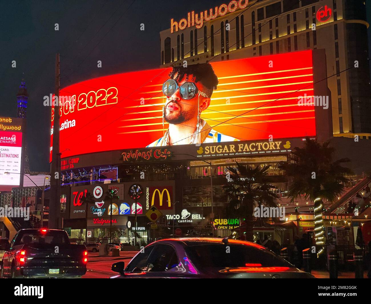 A large digital billboard promoting entertainment in front of the