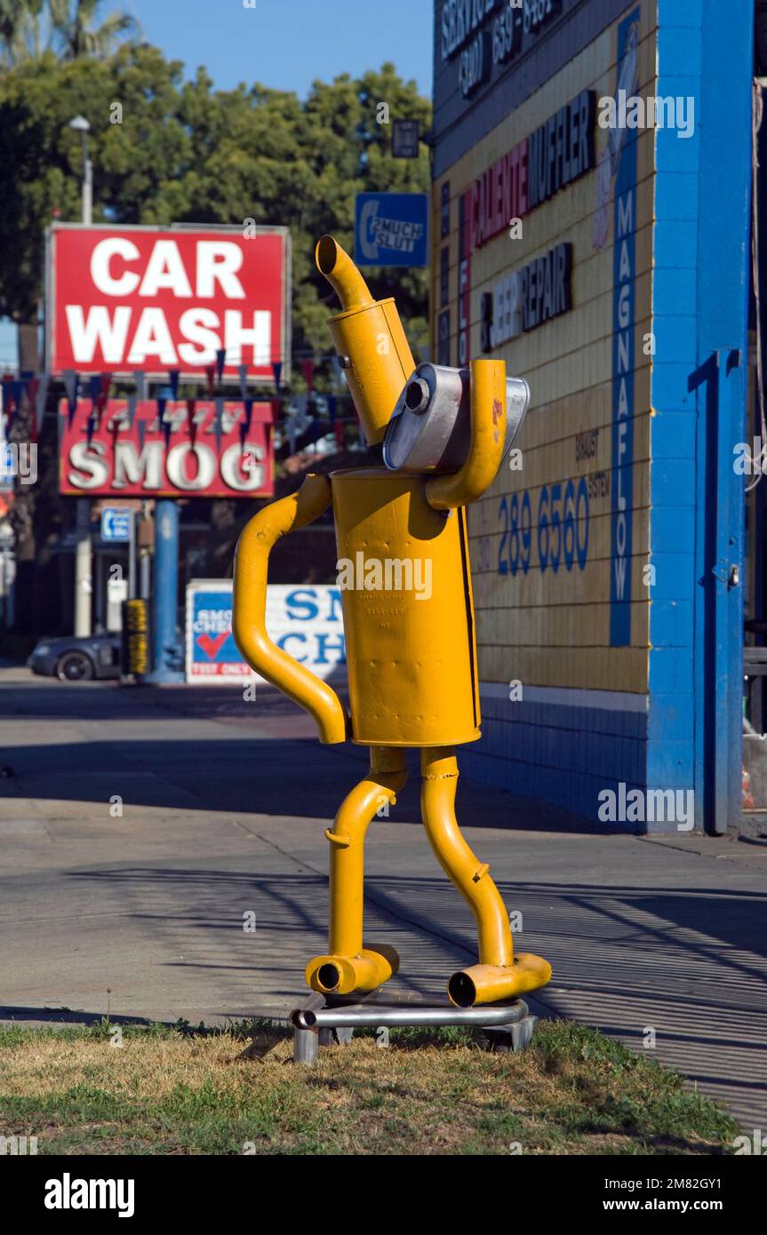 Figure on street made from car parts to promote an auto repair shop on