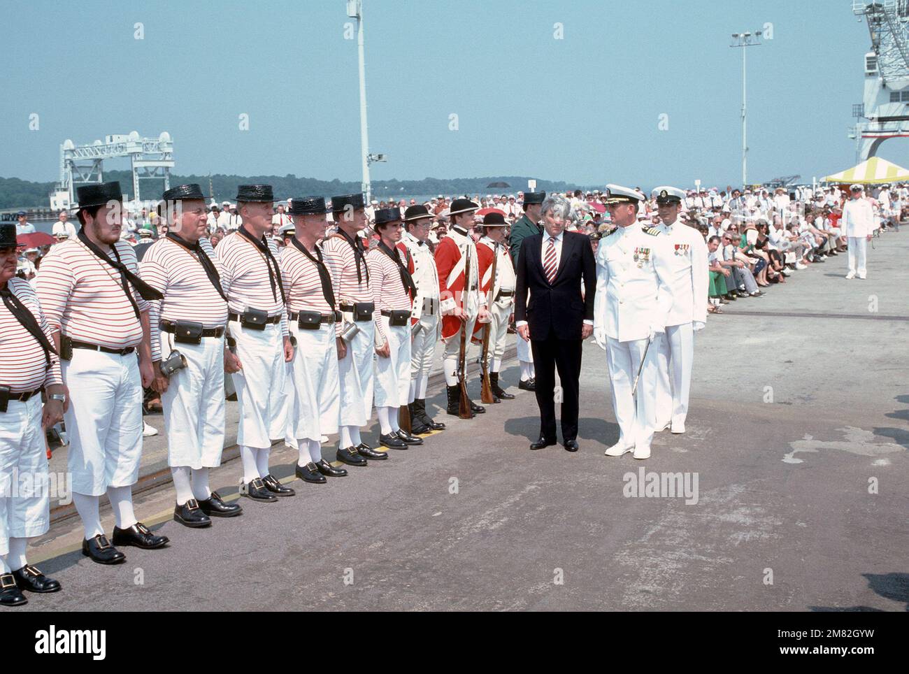 Senator John Warner, R-Virginia, is accompanied by Captain Carl A. Anderson, Commanding Officer of the Aegis guided missile cruiser USS YORKTOWN (CG 48), as they inspect a group of men wearing the uniform of the Colonial Navy of Massachusetts during the commissioning ceremony for the YORKTOWN. Base: Naval Weapons Station, Yorktown State: Virginia (VA) Country: United States Of America (USA) Stock Photo