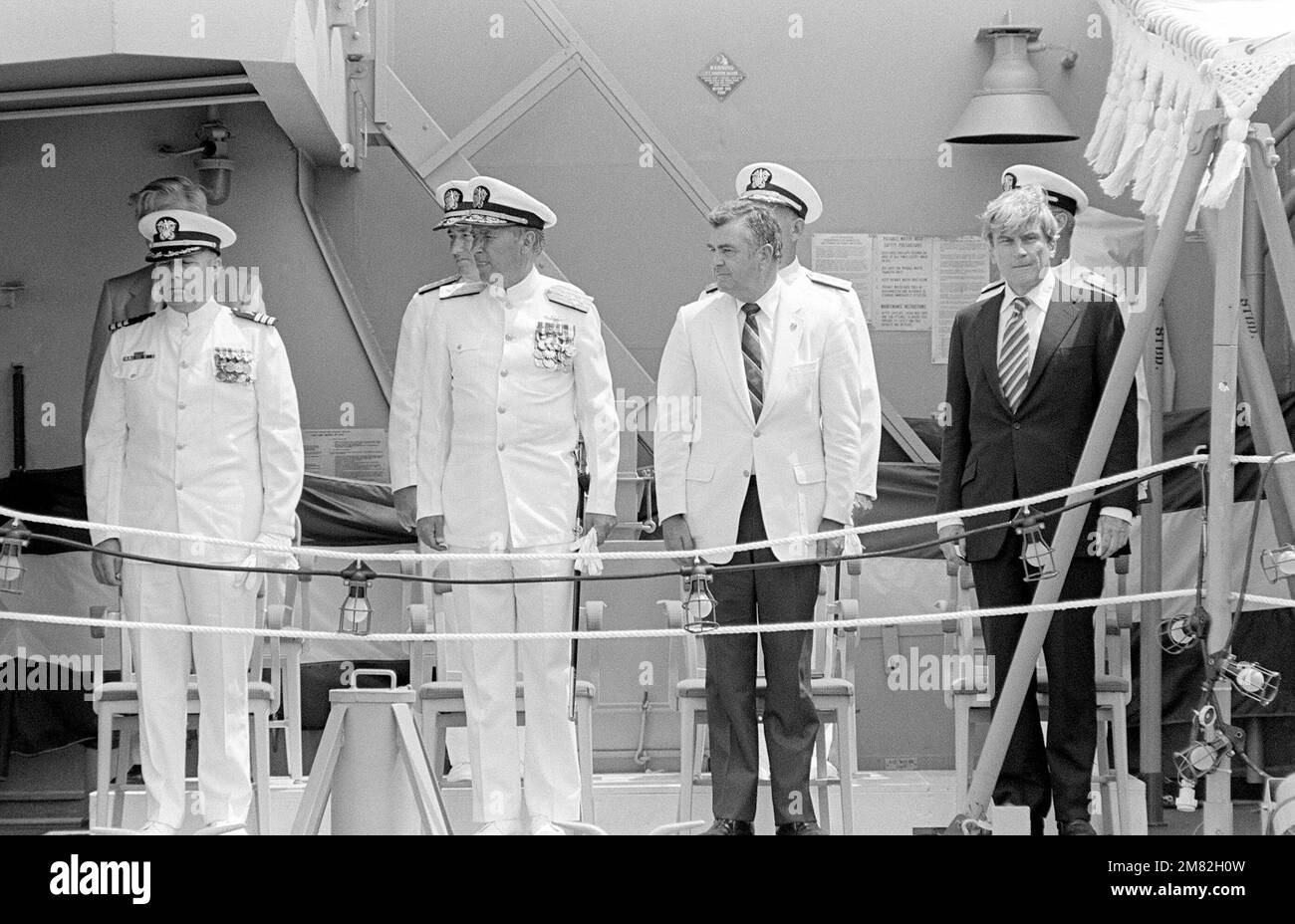 Distinguished guests stand on the quarterdeck of the Aegis guided