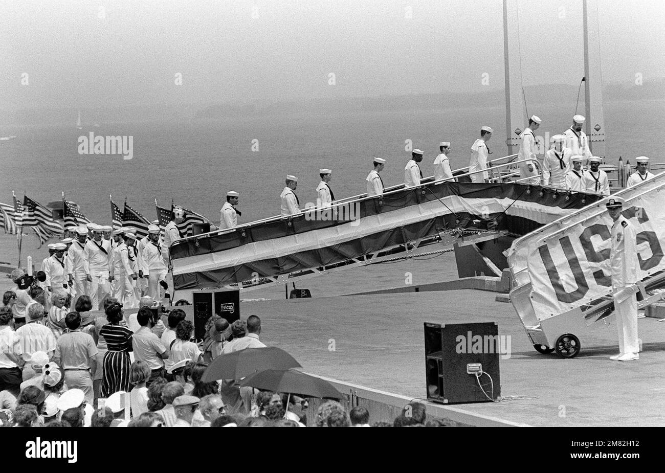 Crewmen go aboard the Aegis guided missile cruiser USS YORKTOWN (CG 48