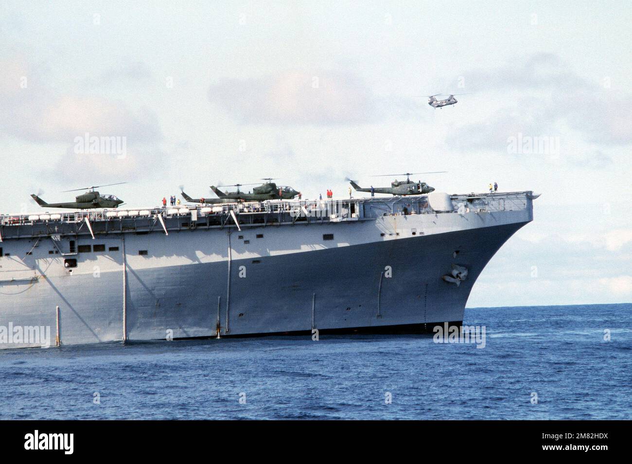 AH 1 Sea Cobra Helicopters And An UH 1 Iroquois Helicopter On The ah-1-sea-cobra-helicopters-and-an-uh-1-iroquois-helicopter-on-the