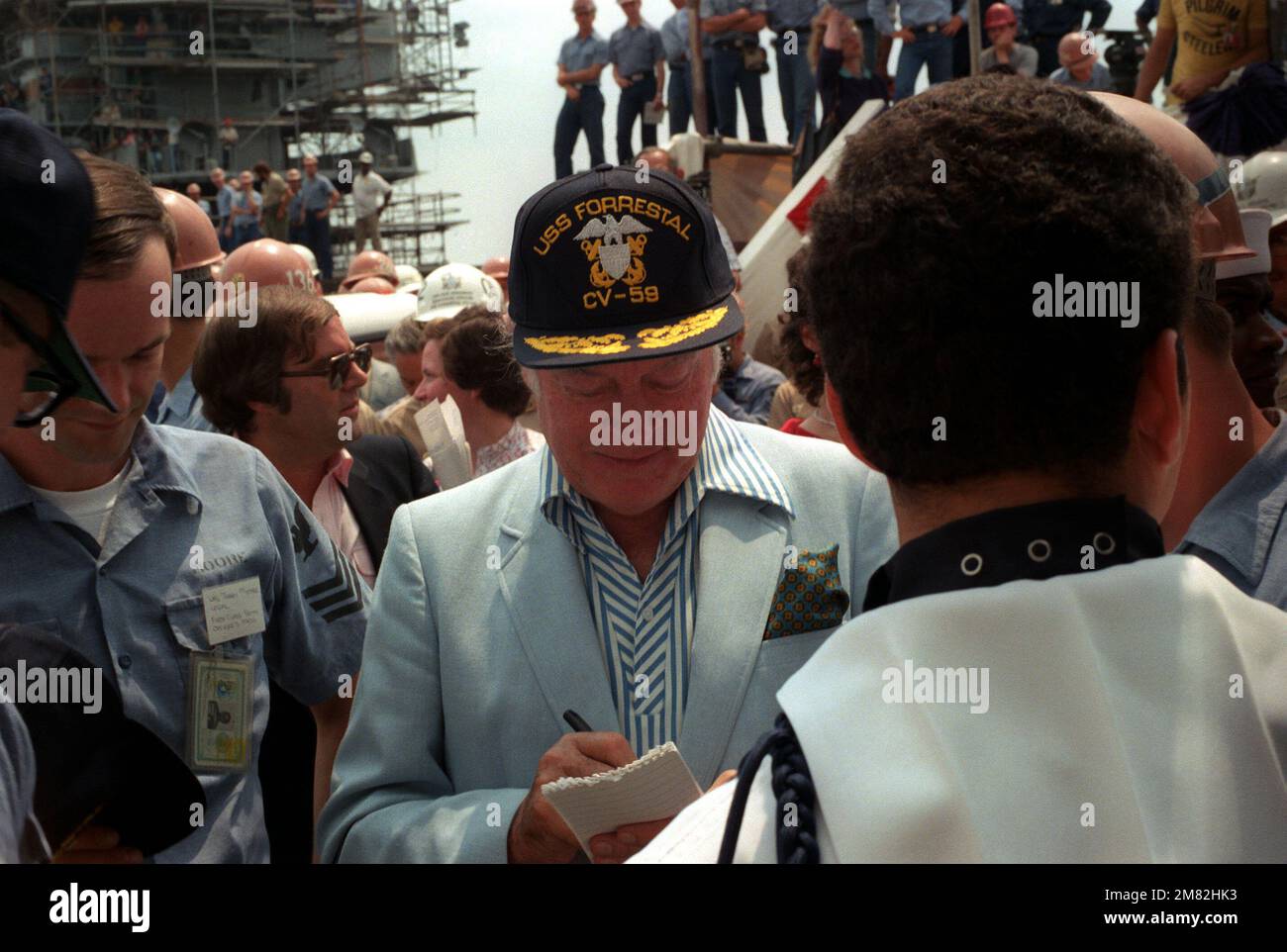 Bob Hope signs autograph after a 30-minute show with actress Ann Jillian on board the aircraft carrier USS FORRESTAL (CV 59). Base: Philadelphia State: Pennsylvania (PA) Country: United States Of America (USA) Stock Photo