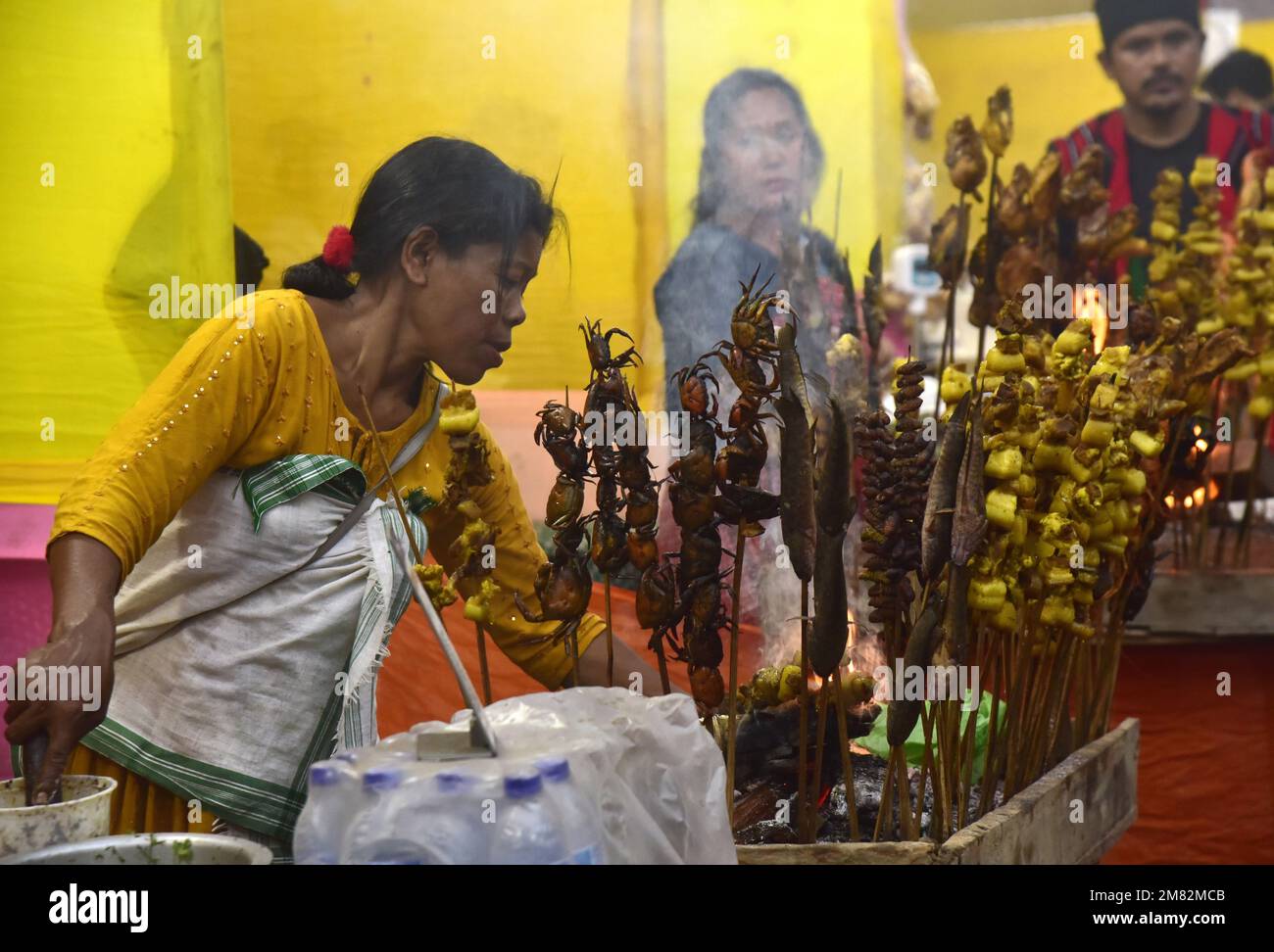 Guwahati, Guwahati, India. 11th Jan, 2023. A tribal woman roast fish, meat and crabs in a