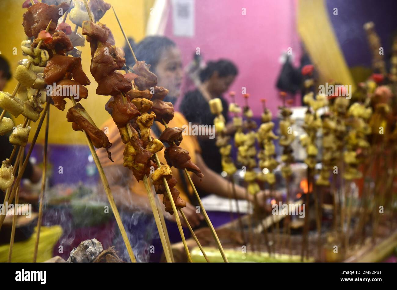 Guwahati, Guwahati, India. 11th Jan, 2023. A tribal woman roast fish, meat and crabs in a