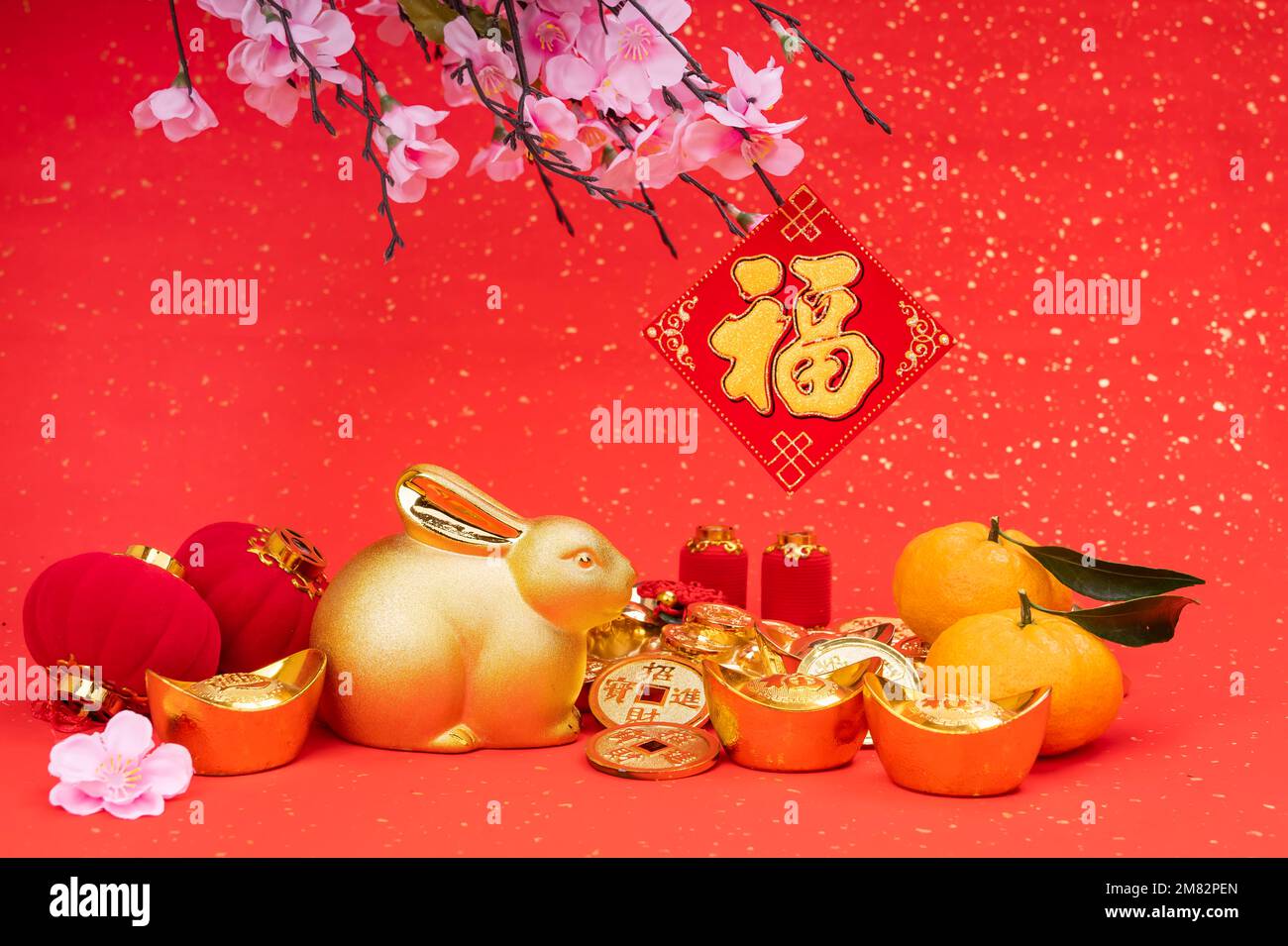 Tradition Chinese golden rabbit statue,2023 is year of the rabbit,Chinese golden characters Translation:good bless for year of the rabbit,word on gold Stock Photo