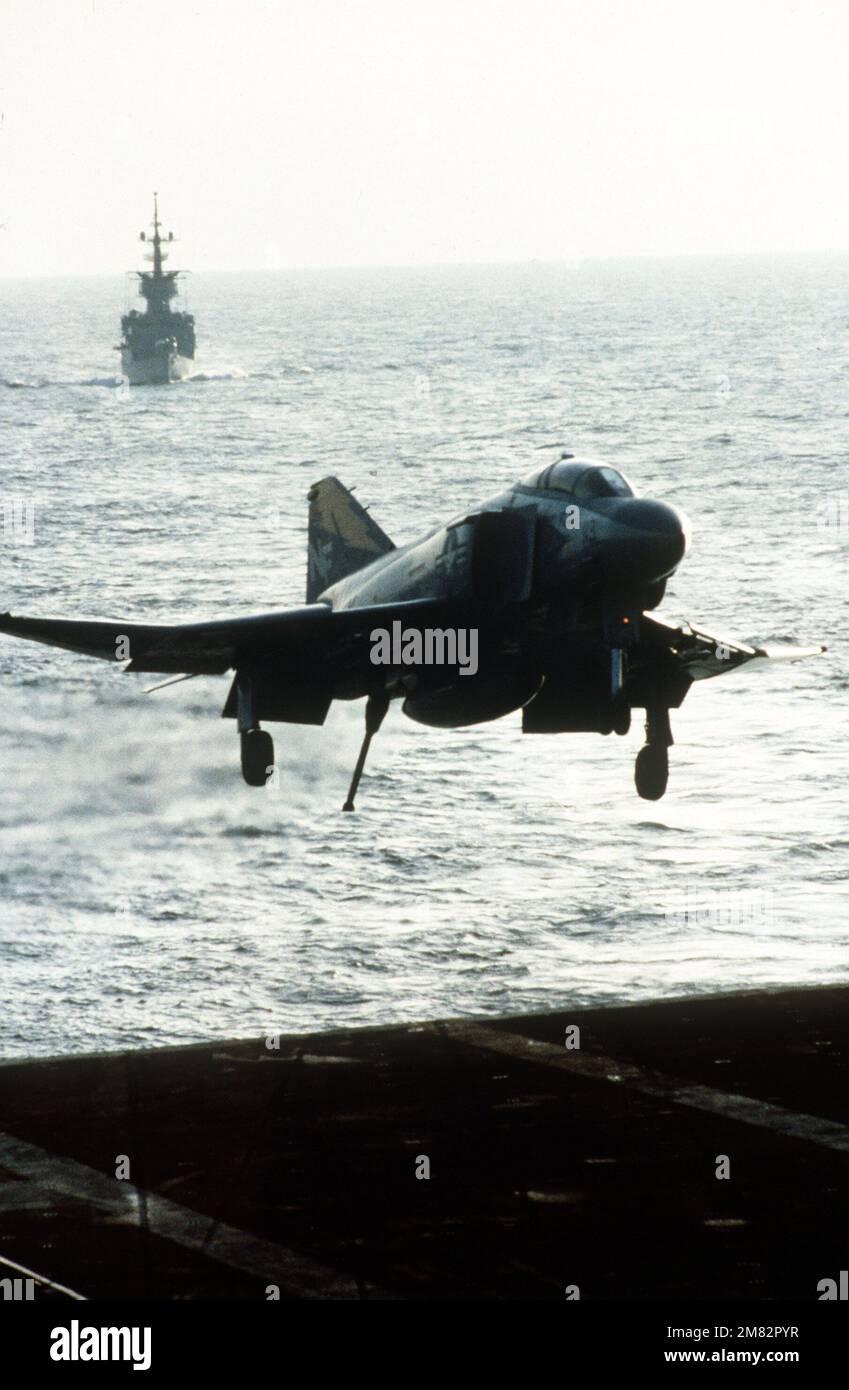An F 4S Phantom II aircraft with tail hook down prepares to land on the flight deck of the aircraft carrier USS MIDWAY CV 41 Country Unknown Stock Photo Alamy