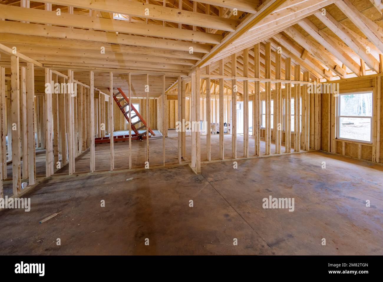 Interior framing of new house that is under construction framework truss beams frame system installed newly built home Stock Photo