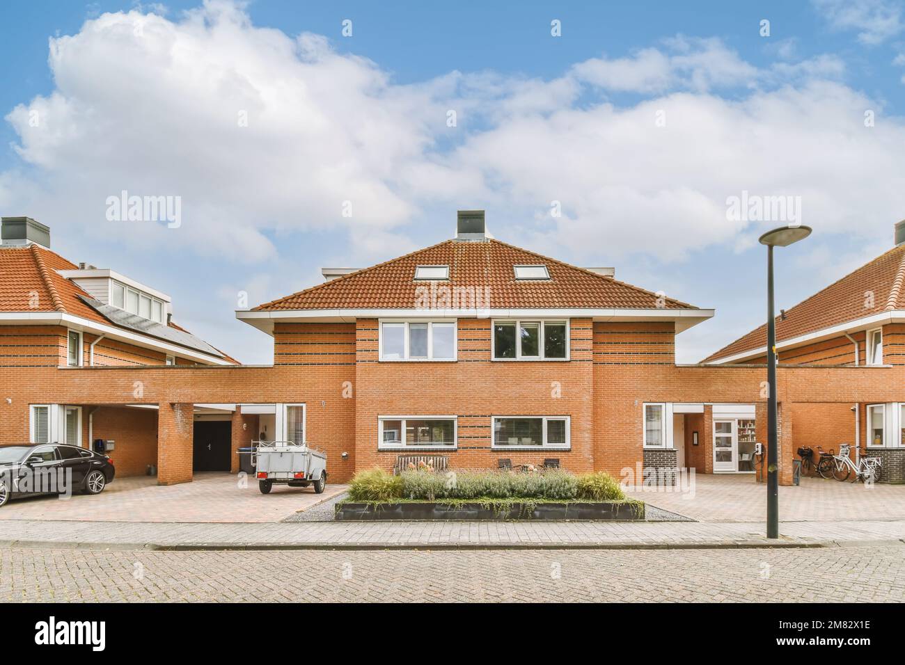 Red brick house with circular driveway and three car garage at twilight  Toronto Ontario Canada Stock Photo - Alamy