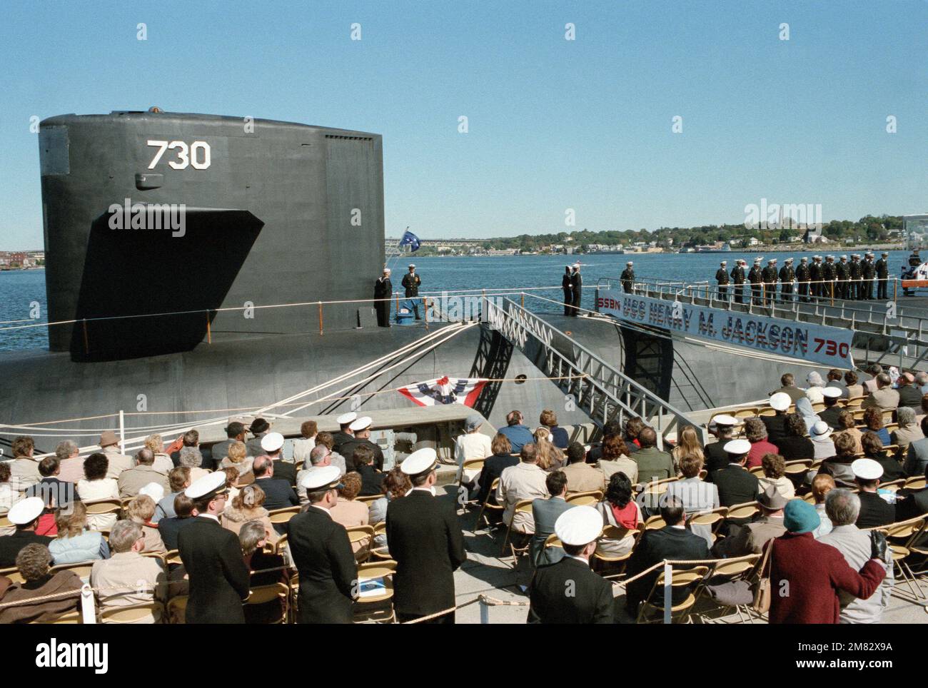 Crewmen raise the admiral's flag aboard the USS HENRY M. JACKSON (SSBN