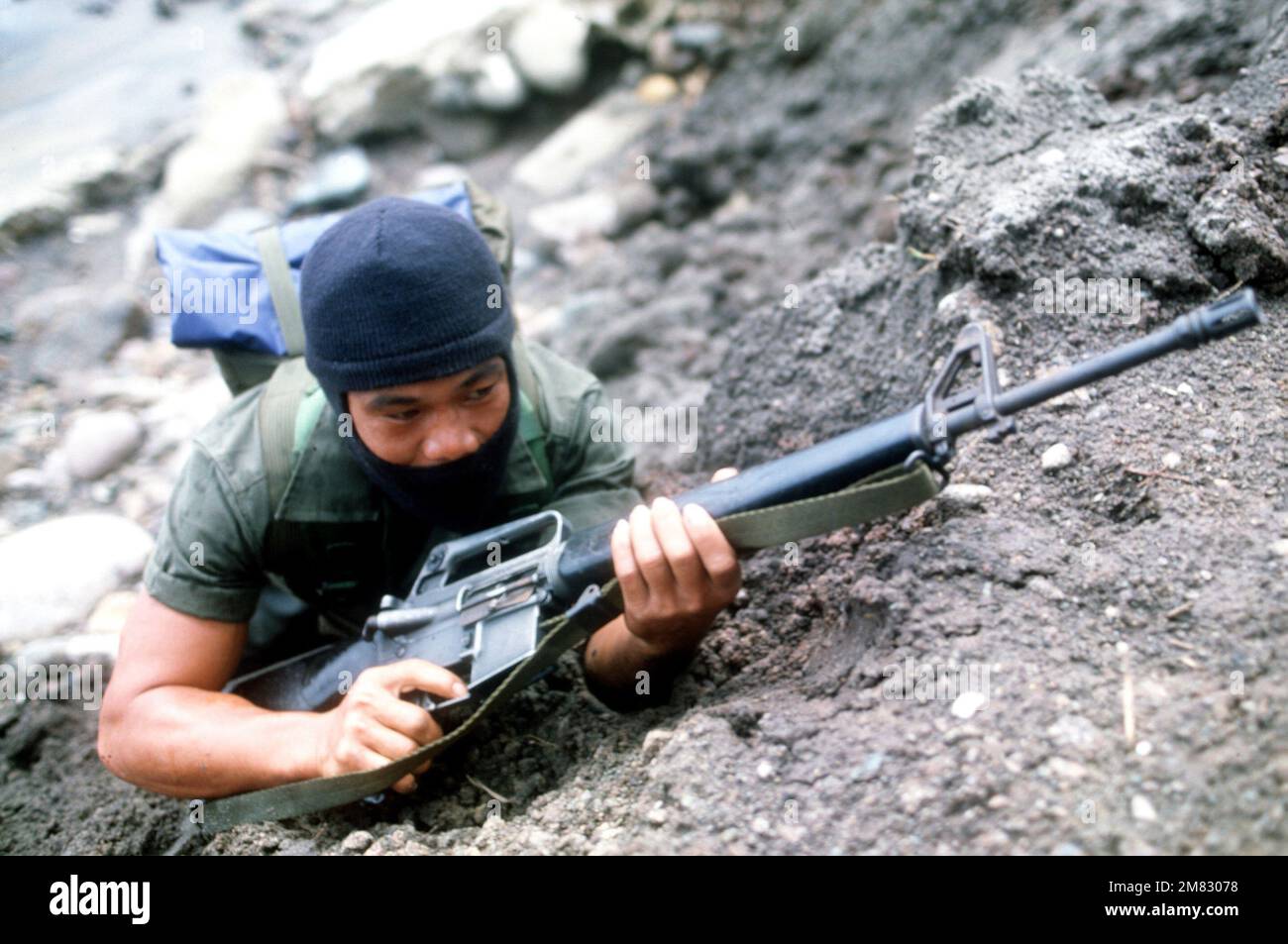A member of the Philippine Special Forces, armed with an M16A1 rifle, prepare for battle as part of the reenactment of General MacArthur's landing at Red Beach on October 20, 1944. Base: Leyte Island Country: Philippines (PHL) Stock Photo