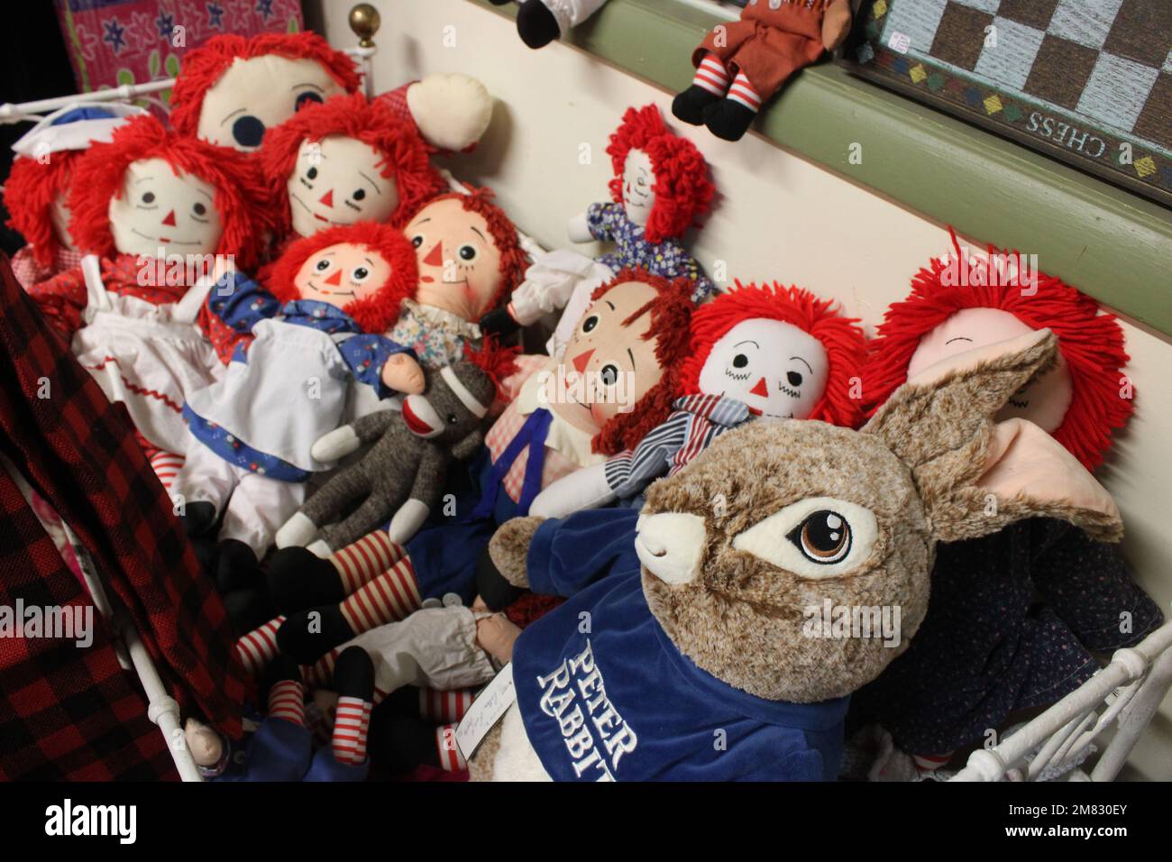 Vintage rag dolls in doll bed Stock Photo Alamy