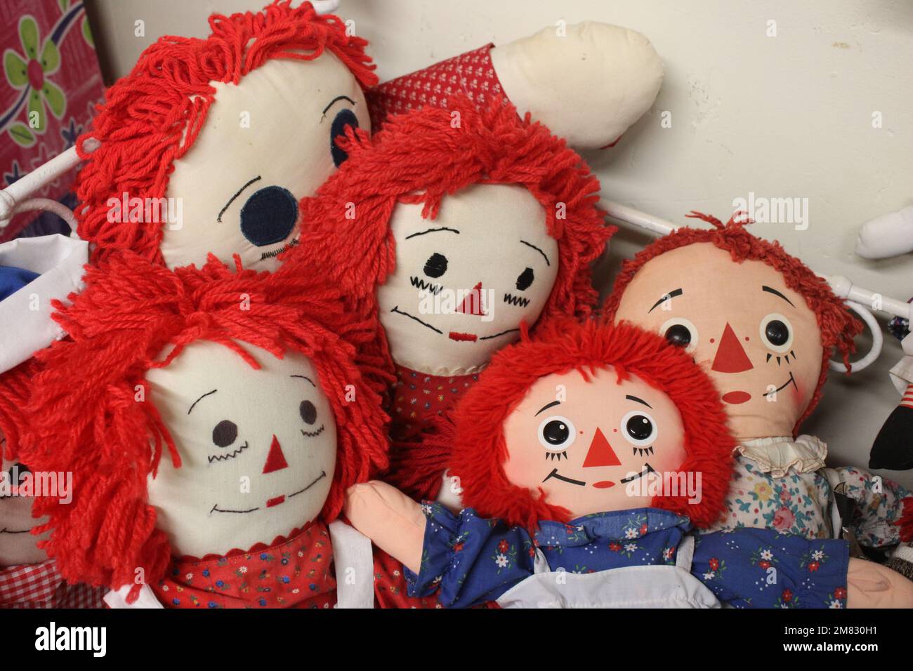 Vintage rag dolls in doll bed Stock Photo